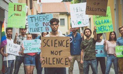 Public demonstration on the street against global warming and pollution. Group of multiethnic...