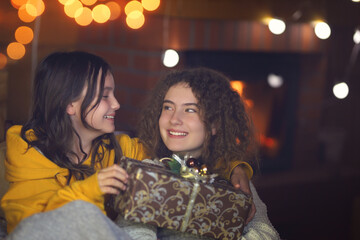 friends on christmas  open a gift in a hut