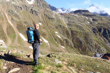 Man looking at mountain panorama with blue sky in Tyrol Alps, Austria