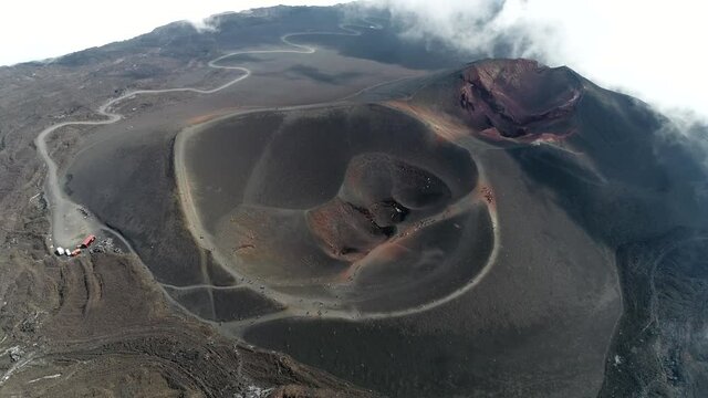Aerial bird view of Mount Etna Barbagallo crater which is part of an active stratovolcano on east coast of Sicily Italy and the summit of the mountain climb therefor a popular tourist destination 4k