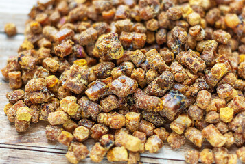 Bee bread on a wooden background. Selective focus. Beekeeping products. Top view. Alternative medicine. Healthy food concept.