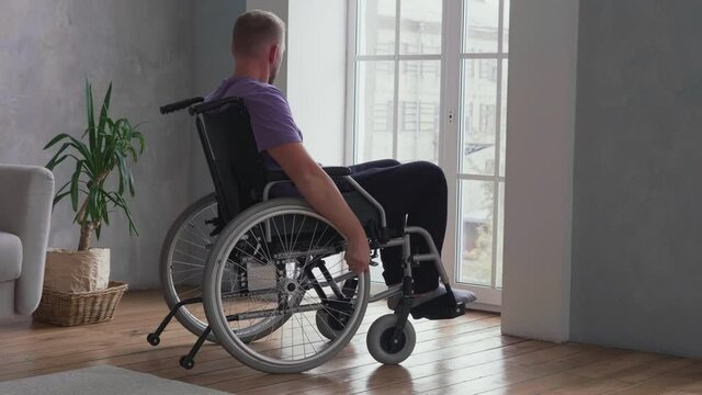 Man sitting in wheelchair at home