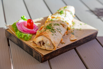 Delicious kebab in oriental pita bread. Served with onions and tomatoes