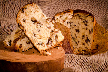 slice of chocolate cake panettone on the wood table. photo close up
