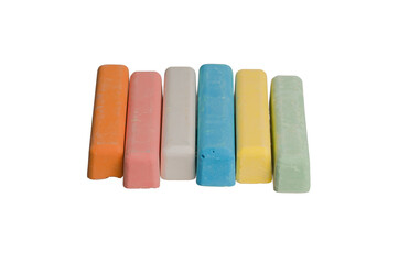 colored crayons lie in one row on a white isolated background