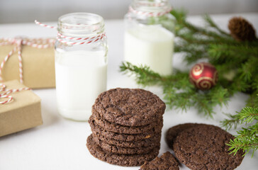 Chocolate Chip Cookies on a White Plate with Milk Bottles. Christmas concept
