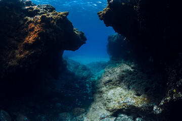 Underwater scene with rocks in blue sea