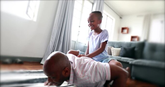 Father doing push-ups with small boy on his back. Black dad doing sport at home with kid