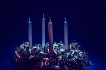 advent wreath with candles on black background
