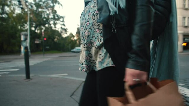 A pregnant no face woman walks down the busy street with a paper bag in her hands. Multiple vulnerability markers in pregnant women living in an urban area.