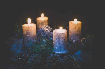 four burning candles on advent wreath