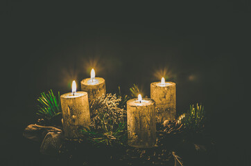 four burning candles on advent wreath