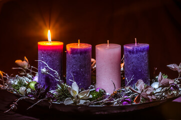 one burning candle on advent wreath - 388096961