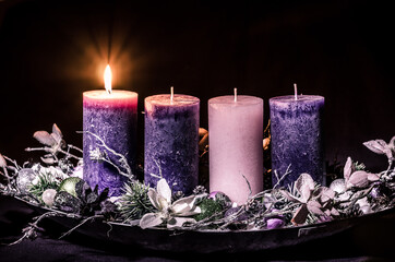 one burning candle on advent wreath - 388096969