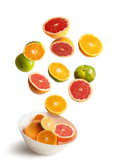 Bowl with assorted oranges and tangerines flying, isolated on the white background