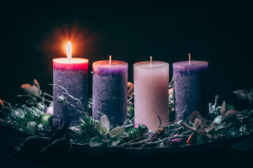 one burning candle on advent wreath - 388096999