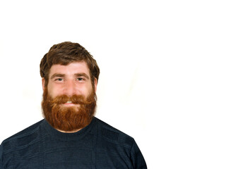 Obraz premium Attractive smiling young man with red beard on white background looking at camera