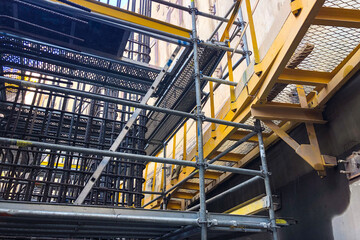 Metal scaffoldings at construction site. Auxiliary supporting structures