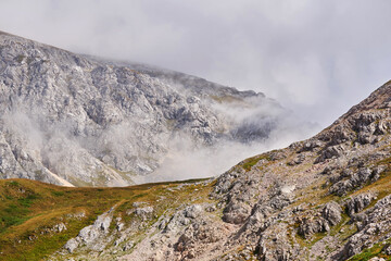 rocky mountain landscape with clouds rising from the gorge