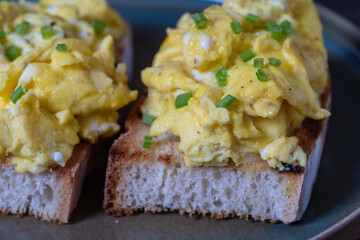 Scrambled eggs on toasted bread for healthy breakfast or brunch