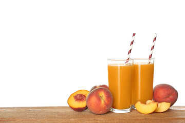Natural freshly made peach juice on wooden table, white background