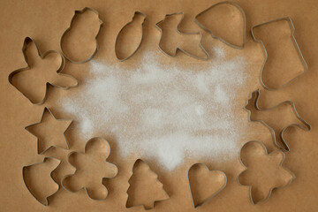 cookie cutters and cookies not a wooden background with icing sugar