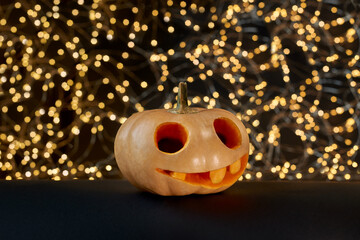 Halloween pumpkin lantern on a black paper background with light
