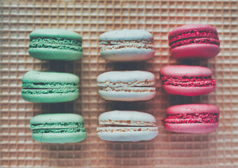Colored macarons on waffle background