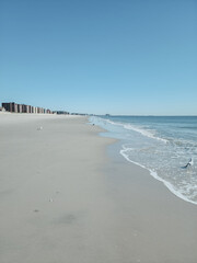 City Beach, Rockaway beach, quiet and empty ocean with a peaceful glow in the background. New York