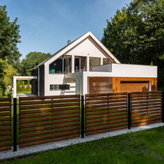 Modern house with wooden style fence