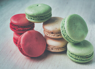 Colored macaroons on grey wooden background