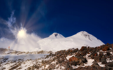 Fototapeta na wymiar Sun light on Elbrus double peak