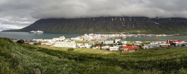 Fototapeta na wymiar Wide-angle panorama of the Isafjordur city in Iceland with storm and fog