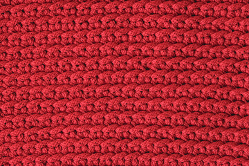 Red knitted fabric texture background. Top view. Copy, empty space for text
