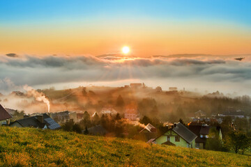 Fototapeta na wymiar sunrise, town in the fog, beautiful landscape