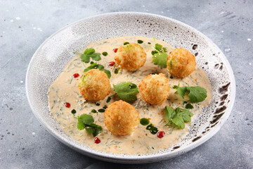 Oriental cuisine. Falafel with sauce, coriander on a light plate. Fried chickpea balls. Restaurant menu. Background image, copy space