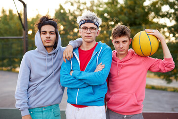 friendly group of caucasian teenagers boys ready to play basketball, athletic young guys full of energy and strength. people, youth, young generation concept