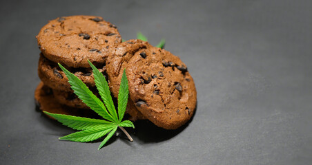 Cannabis leaf. Chocolate cookies. Marijuana food. Medical weed edibles. CBD oil. Copy space