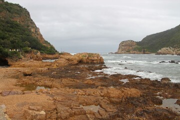 Fototapeta na wymiar The Knysna Heads, sandstone cliffs that separate the Knysna Lagoon from the pacific ocean. A famous landmark along the renowned Garden Route, South Africa, Africa.