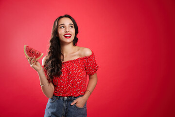 Beautiful young woman with watermelon on red background. Space for text