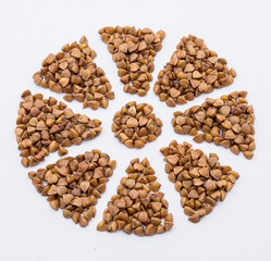 buckwheat on a white background, buckwheat porridge, snowflake from buckwheat grains, flower from cereals