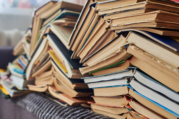 Old books piled up in a heap, learning and education concept.