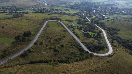 Aerial Drone Shot Of Winding Road By Mountain In Remote Ukraine.