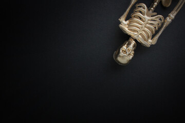 golden skeleton on a black background. Halloween concept.