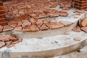 Natural stone cladding master - finishing a concrete porch with decorative tiles