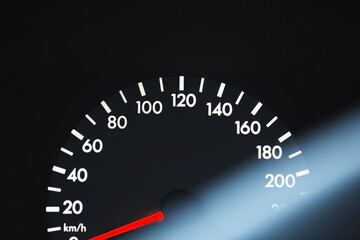 Black car speedometer with red arrow and white numbers - thirst for speed