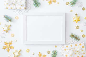 Mockup white frame with fir branches, christmas baubles decoration, gift box and snowflakes on a...