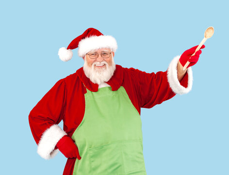 Santa Claus isolated on blue is wearing a green apron.