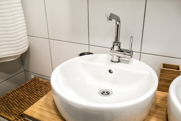 Modern sinks with a mirror in a public toilet. Bachelor's reflection in the mirrors.