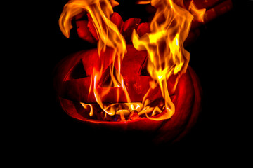 Burning halloween pumpkin head at night on dark background. Halloween dark festive background. Soft focus